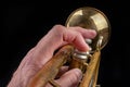 Old trumpet on a dark wooden table. Wind instrument in the old style Royalty Free Stock Photo