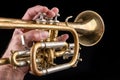 Old trumpet on a dark wooden table. Wind instrument in the old style