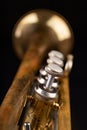 Old trumpet on a dark wooden table. Wind instrument in the old style Royalty Free Stock Photo