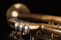 Old trumpet on a dark wooden table. Wind instrument in the old style Royalty Free Stock Photo