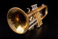 Old trumpet on a dark wooden table. Wind instrument in the old style Royalty Free Stock Photo