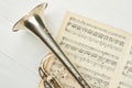 Old trumpet on musical notes close up. Royalty Free Stock Photo