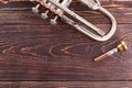 Old trumpet on wooden background.