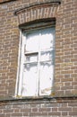 old, tumbledown christian window surrounding red brick