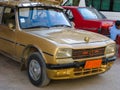 Old tuned taxi in Egypt camel color paint, tiger print seat covers and camel hood ornament