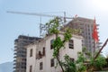 An old Turkish house against the backdrop of modern tall buildings under construction Royalty Free Stock Photo