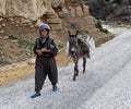 Old Turkish women walking on the road.