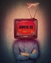 Old tv box instead of journalist head, shows the latest news on the screen. Warning rapidly spreading Coronavirus COVID-19. Royalty Free Stock Photo