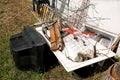 Old TV set and the rest of bulky trash. Old TV thrown away next to a wall with a pile of mixed garbage. Royalty Free Stock Photo