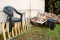 Old TV set and the rest of bulky trash. Old TV thrown away next to a wall with a pile of mixed garbage. Royalty Free Stock Photo