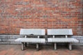 Old twin chairs near grungy red brick wall Royalty Free Stock Photo