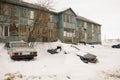 Old two-storied blue house in winter with snow outdoor. Poverty and misery, North