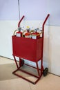 Old two- wheel mobile fire cart filled with three red extinguish Royalty Free Stock Photo