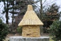 Old type beehive made of strew on a millstone.