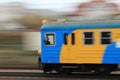 Speeding blue and yellow train Royalty Free Stock Photo