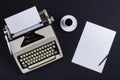 Old typewriter with blank paper near cup of coffee, ready for jounalist action. Royalty Free Stock Photo