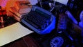 Old typewriter on desk, telephone, mystery detective concept, writer`s work tools, blue backlight Royalty Free Stock Photo