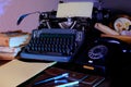 Old typewriter on desk, telephone, mystery detective concept, writer`s work tools, blue backlight Royalty Free Stock Photo