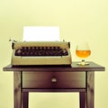 Old typewriter and liquor Royalty Free Stock Photo