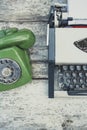 Old typewriter and old green phone Royalty Free Stock Photo