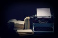 Old typewriter with opened books retro colors on the desk