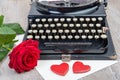 Old typewriter with a red rose Royalty Free Stock Photo