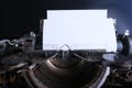 Old typewriter on table, blank white sheet for text, mockup, retro style, concept of works of a writer, journalist Royalty Free Stock Photo