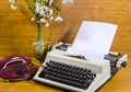 Old typewriter, telephone and ancient vase with camomiles Royalty Free Stock Photo