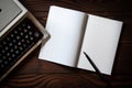 Block notes and old typewriter on wooden table Royalty Free Stock Photo