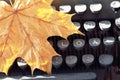 Old typewriter with yellow maple leaf