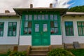 Old typical romanian house facade with green painted wood doors and windows. Royalty Free Stock Photo