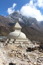 Old typical white Buddhist stupa at the foot of mountain in Nepal Royalty Free Stock Photo