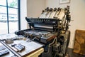 Old typography printing machine with letter samples.