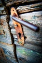 The old ugly rusty latch on wooden door Royalty Free Stock Photo