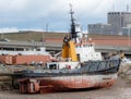 An old, unidentified tugboat resting at low tide Royalty Free Stock Photo