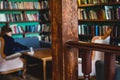 Old university college library interior with a bookshelves, books and bookcase, classic style school interior archive with wooden