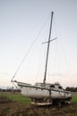 An old, unusable yacht on land