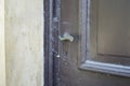 Old unused wooden door with a metal door handle.