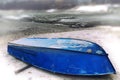 Old Upturned Boat Blue Lies on the Shore of the Dried Lake . Royalty Free Stock Photo