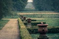 Old urns on pillars in an abandoned garden in the countryside. Sense of loneliness or solitude