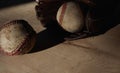 Old used baseball balls with glove