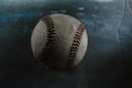 Old used baseball closeup with dark vintage texture