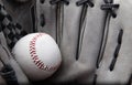 Old used baseball glove and ball isolated closeup Royalty Free Stock Photo