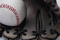 Old used baseball glove and ball isolated closeup Royalty Free Stock Photo