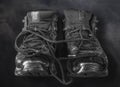 Old used black working pair of boots on a dark background Royalty Free Stock Photo