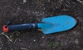 old blue gardening spade on soil