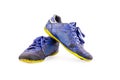 Old used blue worn out futsal sports shoes on white background soccer sportware object isolated