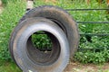 Old used car tires stand at the fence of a summer cottage. Royalty Free Stock Photo