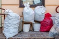 old used clothes in plastic bags. New arrival of the goods in the second-hand store. Humanitarian aid for children affected by the Royalty Free Stock Photo