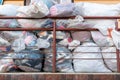 old used clothes in plastic bags. New arrival of the goods in the second-hand store. Humanitarian aid for children affected by the Royalty Free Stock Photo